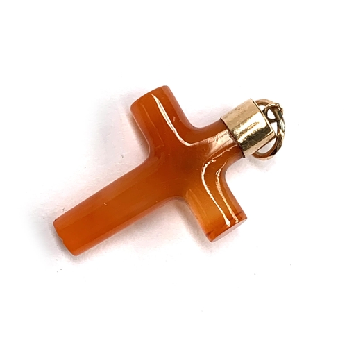 51 - A 19th century carved carnelian cross set with a split pearl, yellow metal capped, 1.8cm wide