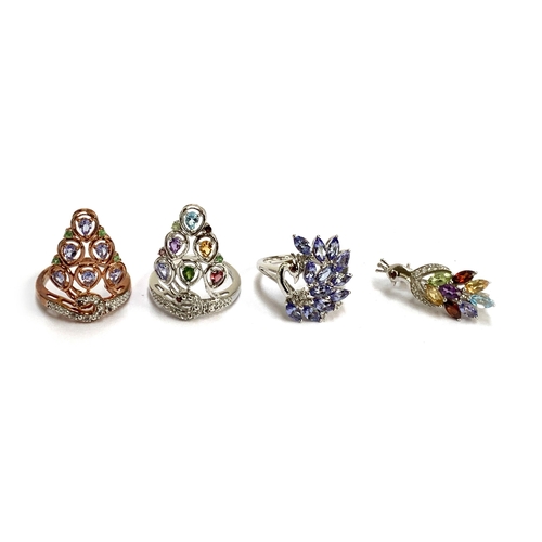 84 - Three silver gem set rings and a brooch in the form of peacocks, set with a variety of gems includin... 