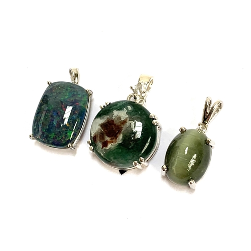 88 - Three silver pendants, an Aquaprase cabochon and white zircon, 2cmD; Cats eye; and opal triplet, 16g... 