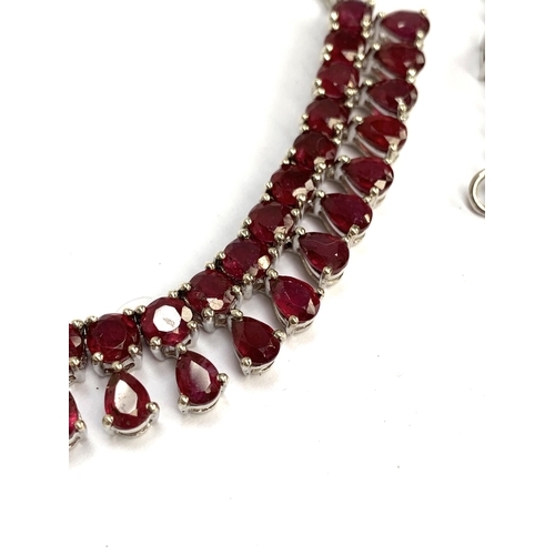 91 - A sterling silver and ruby fringe necklace, the madagascan rubies totalling 22.8cts; together with a... 