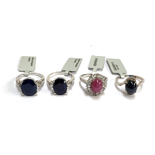 92 - Four silver rings: one set with a star sapphire and white topaz; one star ruby, 6.2cts, and white to... 