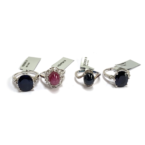 93 - Four silver rings: one set with a star sapphire and white topaz; one star ruby, 6.2cts, and white to... 