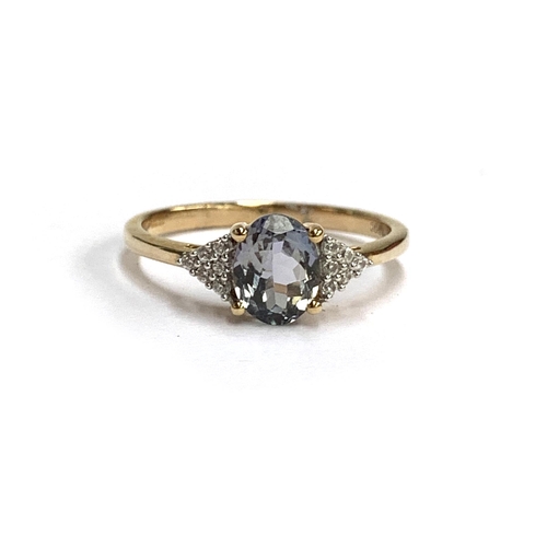 95 - A 9ct gold ring set with a bicolour tanzanite and natural white zircons, size S, 2.4g