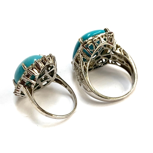 105 - Two 925 silver ring set with large sleeping beauty turquoise cabochons, surrounded by natural white ... 