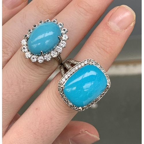 105 - Two 925 silver ring set with large sleeping beauty turquoise cabochons, surrounded by natural white ... 