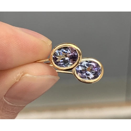 60 - A pair of 9ct gold mounted tanzanite hook earrings, the tanzanite totalling 2.7cts and measuring 8x6... 