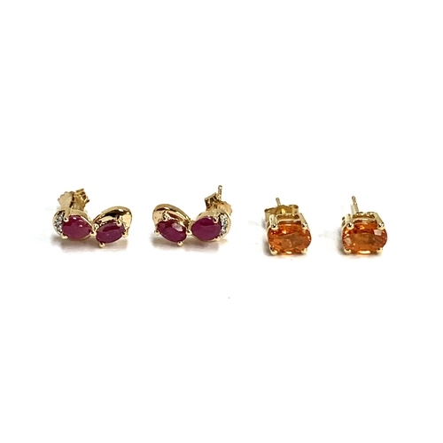 63 - A pair of 9ct gold stud earrings set with mandarin garnets, totalling 2.5cts; together with a pair o... 