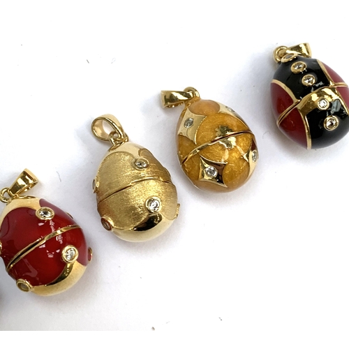 69 - A collection of seven Russian egg style 'Midas Renaissance Egg' silver and enamel pendants, each set... 