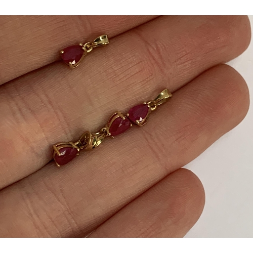 79 - Four small 9ct gold mounted ruby charm pendants, the Burmese rubies each 0.4cts and measuring 5x4mm,... 