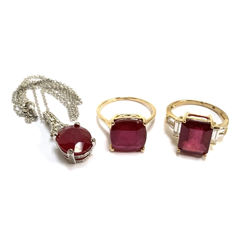 80 - Two 9ct gold ruby cocktail rings, 9.6g gross weight; together with a ruby pendant