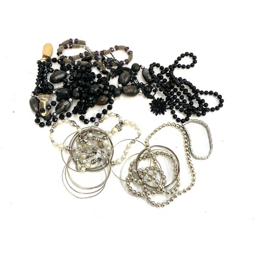 28 - A quantity of gold and silver and black tone costume jewellery