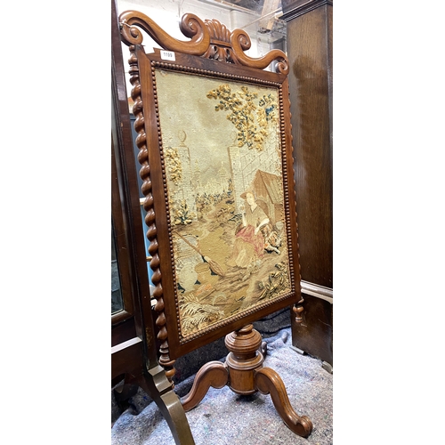 1199 - An early Victorian walnut fire screen with woolwork panel, 112cmH