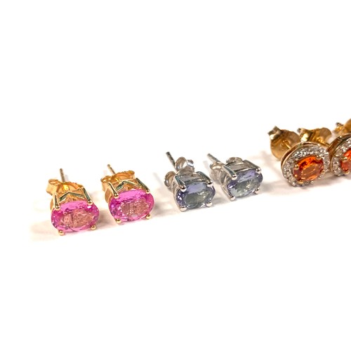 83A - A pair of 9ct gold pink spinel stud earrings, 1.4g; together with a pair of silver mounted tanzanite... 