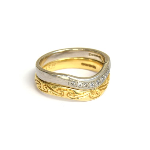 33A - Two stacking 18ct gold and platinum rings, the platinum band set with diamonds, the gold band floral... 