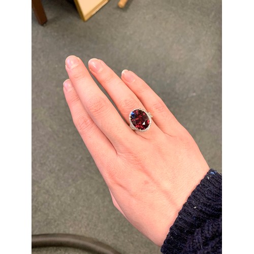 43A - An 18ct gold, red zircon and diamond ring, the large Ratanakiri red zircon 17.9cts and measuring 16x... 