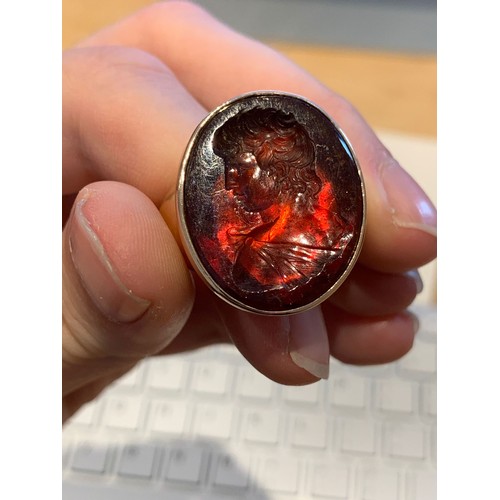 11 - A large and heavy Georgian gold mounted garnet intaglio portrait ring, the gold in two colours, the ... 