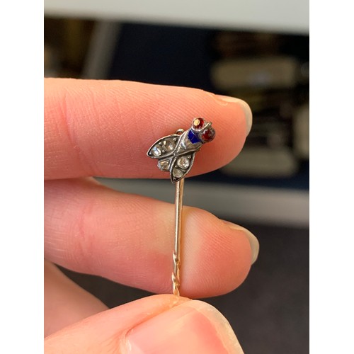 6 - A Victorian gold and silver stickpin in the form of a fly (af), set with rose cut diamonds, red past... 