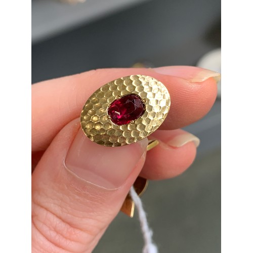 31 - A matched pair of early 20th century French 18ct gold and ruby Art Deco cufflinks with a planished f... 