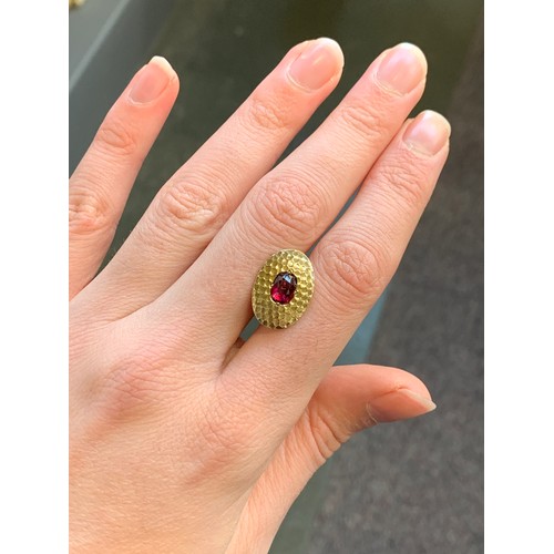 31 - A matched pair of early 20th century French 18ct gold and ruby Art Deco cufflinks with a planished f... 