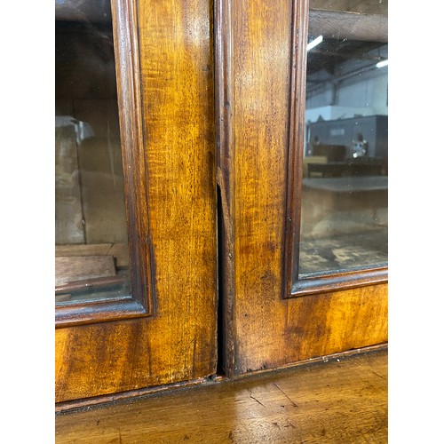 422 - A 19th century glazed breakfront bookcase, the moulded pediment over a four section glazed top, the ... 