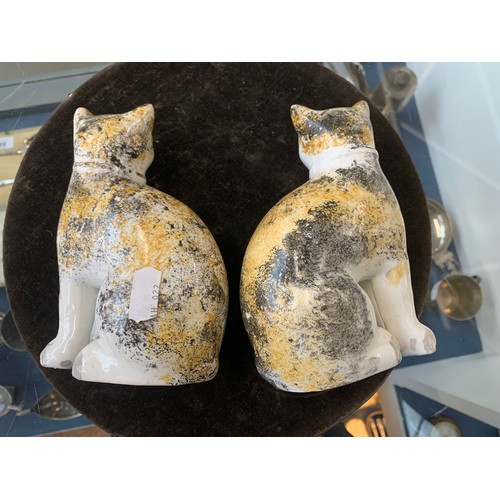 162 - A pair of mid 19th century Staffordshire cats, sponged black and brown colouring, bearing BADA stick... 