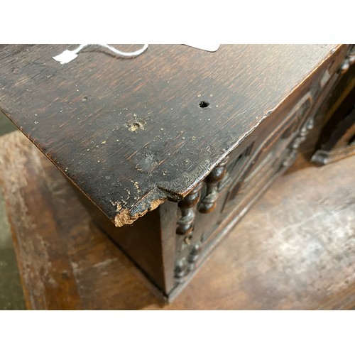 354 - A Charles II oak spice cupboard, the geometric carved door with applied half turned decoration, open... 