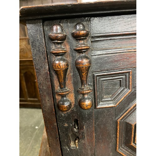 354 - A Charles II oak spice cupboard, the geometric carved door with applied half turned decoration, open... 