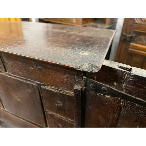 354 - A Charles II oak spice cupboard, the geometric carved door with applied half turned decoration, open... 