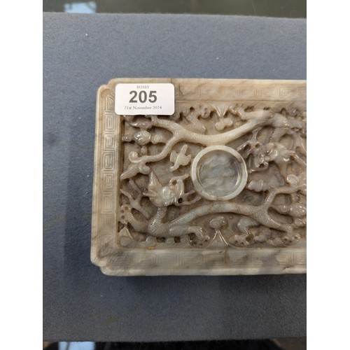 205 - A Chinese grey jade cup stand, of rectangular panel form with canted corners, intricately carved in ... 