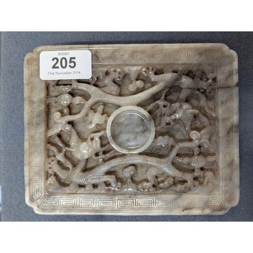 205 - A Chinese grey jade cup stand, of rectangular panel form with canted corners, intricately carved in ... 