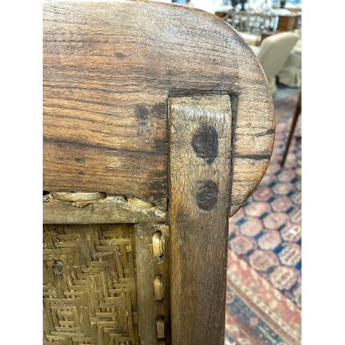 458 - A pair of early 20th century Indian teak planter's chairs, each approx. 64cm wide