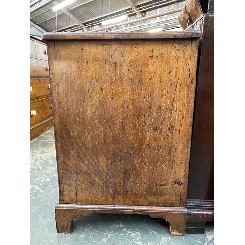 365 - An 18th century walnut kneehole dressing table, the quarter veneered feather banded top over seven d... 