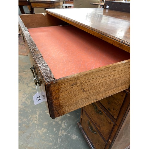 365 - An 18th century walnut kneehole dressing table, the quarter veneered feather banded top over seven d... 