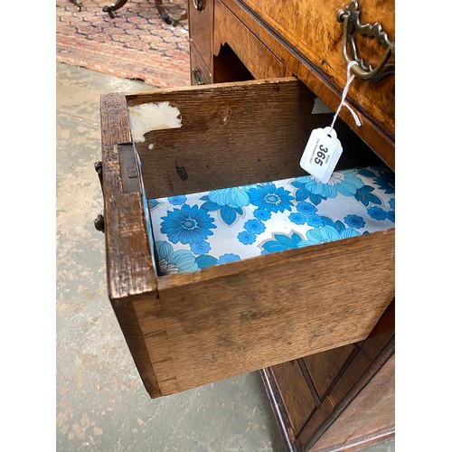 365 - An 18th century walnut kneehole dressing table, the quarter veneered feather banded top over seven d... 