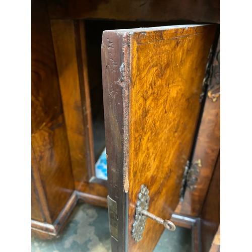 365 - An 18th century walnut kneehole dressing table, the quarter veneered feather banded top over seven d... 