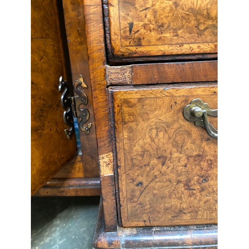 365 - An 18th century walnut kneehole dressing table, the quarter veneered feather banded top over seven d... 