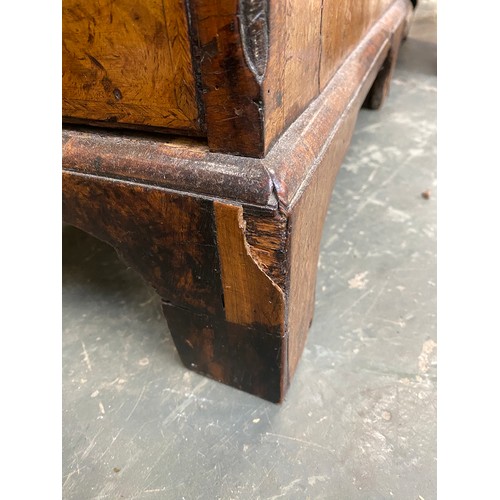 365 - An 18th century walnut kneehole dressing table, the quarter veneered feather banded top over seven d... 