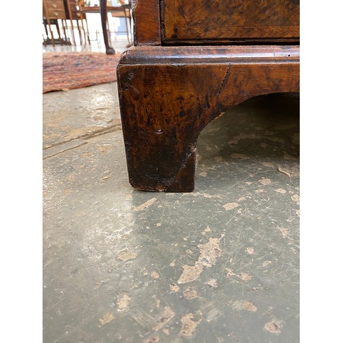 365 - An 18th century walnut kneehole dressing table, the quarter veneered feather banded top over seven d... 