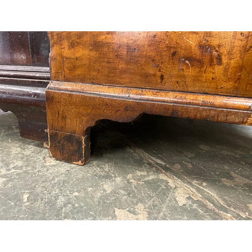 365 - An 18th century walnut kneehole dressing table, the quarter veneered feather banded top over seven d... 