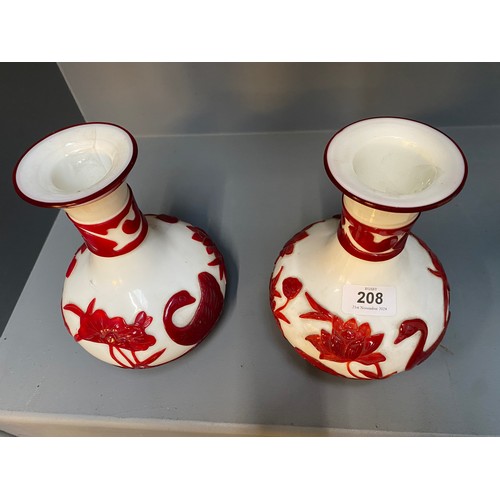 208 - A collection of 20th century Peking glass, comprising: a pair of red overlay glass vases with pine t... 