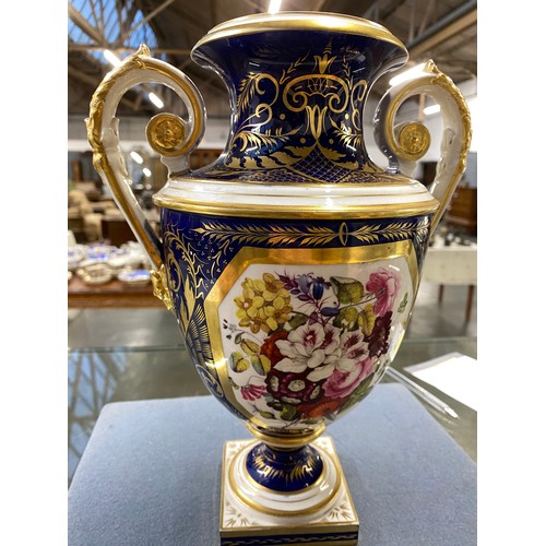 191 - A matched pair of Derby style twin handled urns, cobalt blue and heightened in gilt with large hand ... 