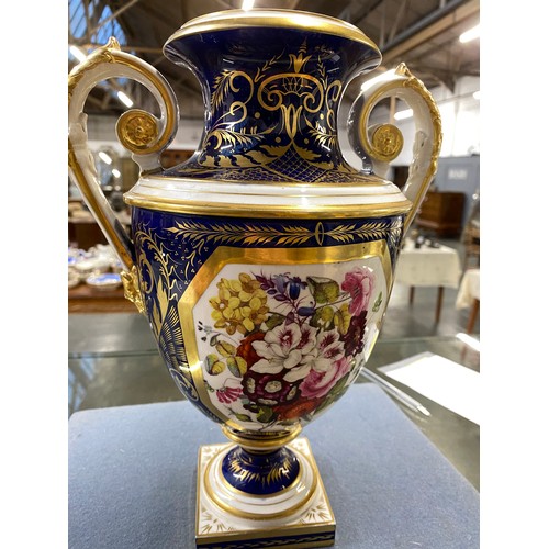 191 - A matched pair of Derby style twin handled urns, cobalt blue and heightened in gilt with large hand ... 