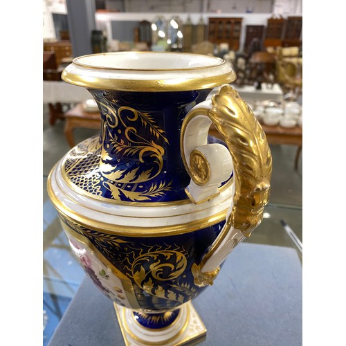 191 - A matched pair of Derby style twin handled urns, cobalt blue and heightened in gilt with large hand ... 