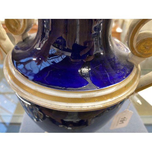 191 - A matched pair of Derby style twin handled urns, cobalt blue and heightened in gilt with large hand ... 