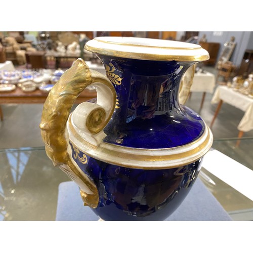 191 - A matched pair of Derby style twin handled urns, cobalt blue and heightened in gilt with large hand ... 