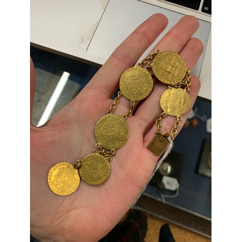 1 - A bracelet formed of George II spade guinea and half guinea gold coins, with a concealed box clasp, ... 