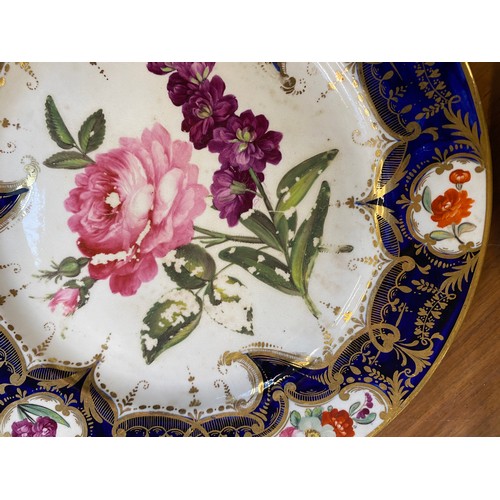 193 - A set of twelve 19th century cobalt blue and gilt dessert plates, each with central hand painted flo... 