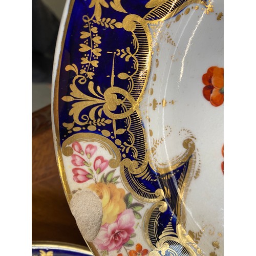 193 - A set of twelve 19th century cobalt blue and gilt dessert plates, each with central hand painted flo... 