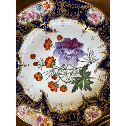 193 - A set of twelve 19th century cobalt blue and gilt dessert plates, each with central hand painted flo... 