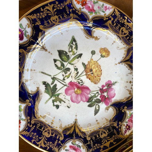 193 - A set of twelve 19th century cobalt blue and gilt dessert plates, each with central hand painted flo... 